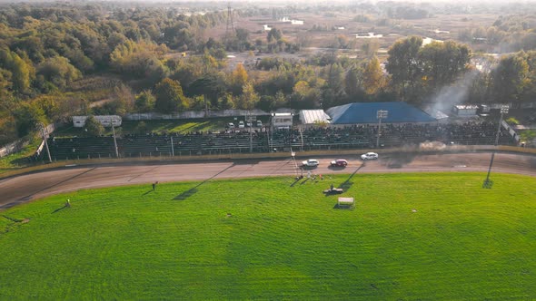 Aerial View on Top Races on the Racetrack, Cars Driving in a Circle Drifting Around Corners Compete