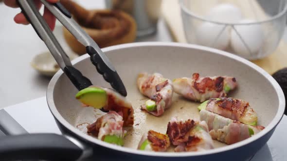 Crop unrecognizable person preparing fried avocado and bacon in kitchen