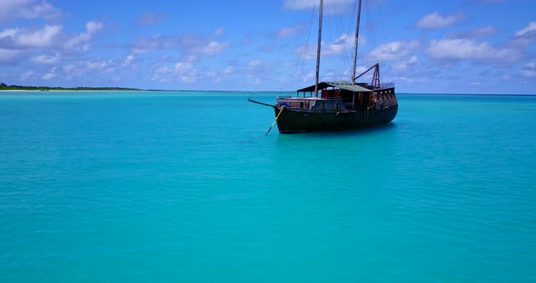 Beautiful above tourism shot of a sunshine white sandy paradise beach and blue ocean background in b