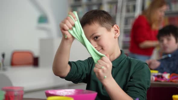 Cute Autistic Boy Playing Slime at Master Class