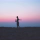 Silhouette of woman waving towards camera at sunset - VideoHive Item for Sale