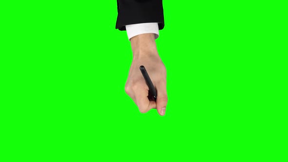 Male Hand in a Black Jacket and White Shirt with Liner Pen Is Writing on Green Screen Background