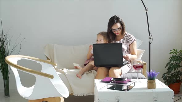 Business Woman Working at Home with Her Child