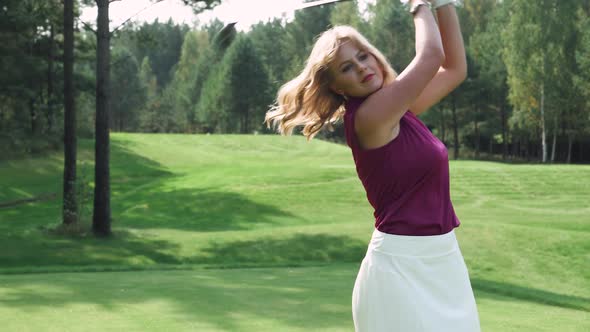 Summer Day Woman Playing Golf Hits the Ball View of Golf Course in Forest Area Green Lawn