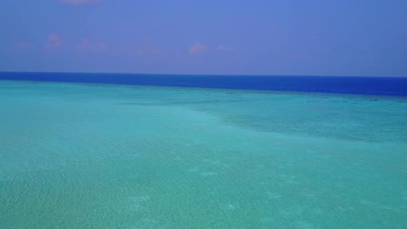 Aerial travel of marine coastline beach by blue ocean with sand background