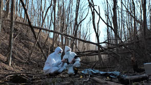 Forensic specialists working in the forest. Crime scene and police concept.