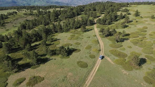 Offroad Vehicle Driving On Mountain Top And Green Mountain Landscapes