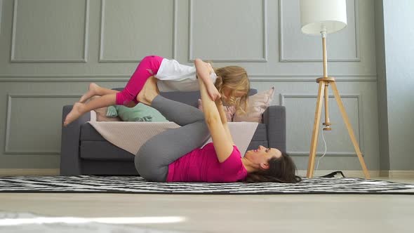 Mother and Daughter Doing Yoga in Quarantine