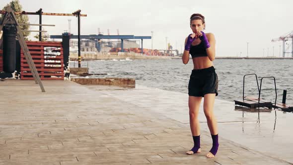Athletic Young Woman Shadow Boxing By the Sea