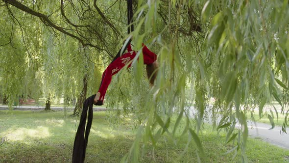 Slow Motion of a Girl That Climbs Up on Aerial Silk