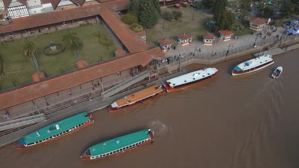 Aerial view of a some boats docked revealing Tigre river path and horizon at background