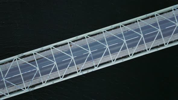 Bird's Eye View of a Bridge Spanning a Fast Flowing Dark River