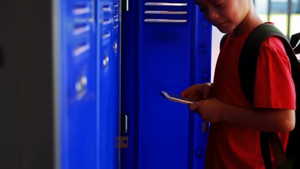 Schoolboy using mobile phone in locker room 4k