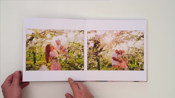 White Background Leaf Through Photobook From Family Photo Shoot in Spring Garden