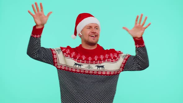 Man in Christmas Sweater Listening Music Via Earphones Dancing Disco Fooling Around Having Fun