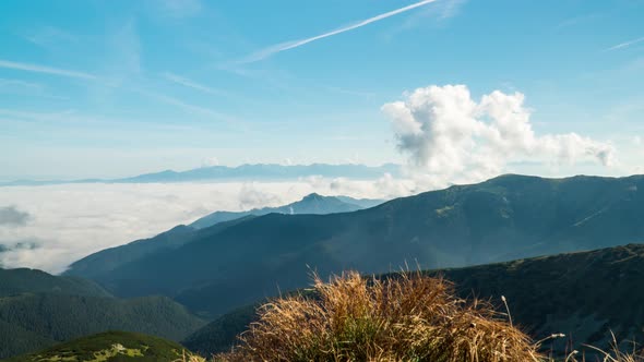 Creating of a cloud formation high above the valley on sunny morning, Slovakia, Low Tatras