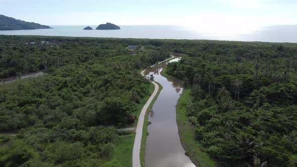 Aerial view fly over winding river toward sea.