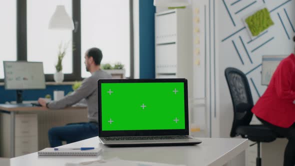 Close Up of Laptop with Green Screen on Empty Desk