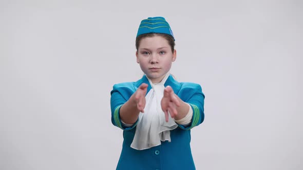 Front View of Concentrated Caucasian Girl Showing Emergency Exits Gestures and Smiling Posing in