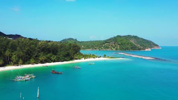 Aerial flying over texture of tranquil seashore beach time by transparent ocean with white sand back