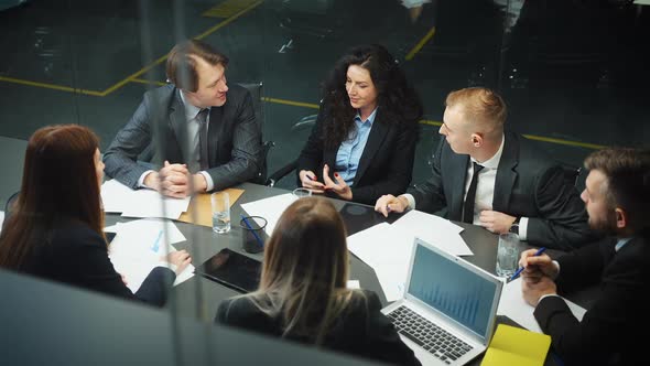 Business People Discussing Progress at Meeting Top View