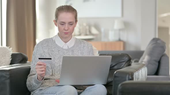 Successful Online Payment on Laptop By Young Woman at Home 