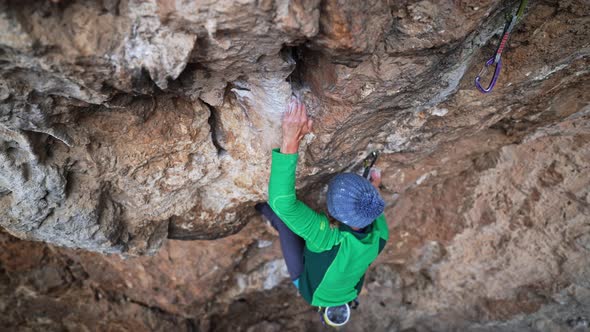 Slow Motion Top View Strong Woman Rock Climber Climbs on Overhanging Cliff By Hard Route