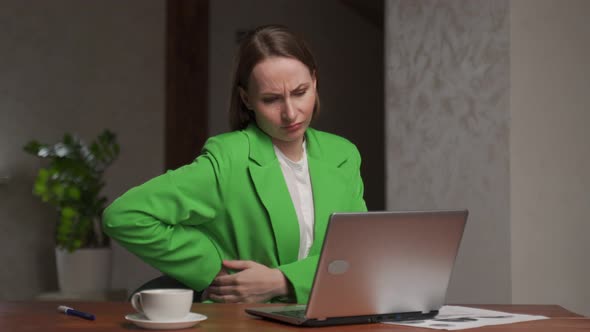 Tired Woman Kneads Stiff Back Working Long Time on Laptop