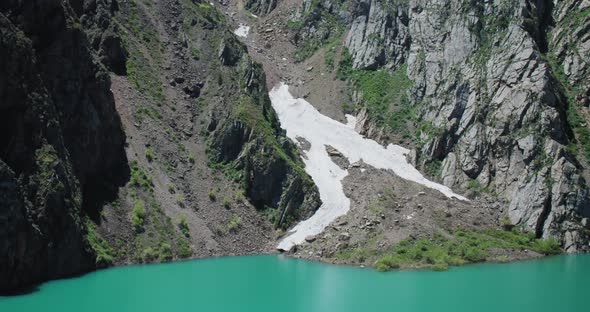 Mountain Lake of green and blue color Urungach. And Snow glacier. The beauty located in Uzbekistan,