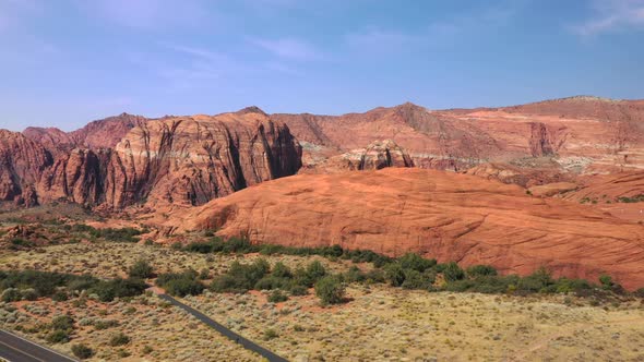 Scenic Asphalt Road With Vermillion Cliffs In Arizona Utah, USA. Aerial Tilt-Up Shot