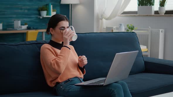 Cheerful Woman Attending Online School Lesson on Laptop