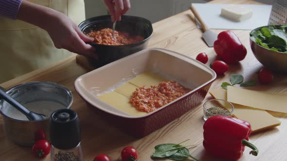 Woman Is Putting Hot Sauce In Ovenware