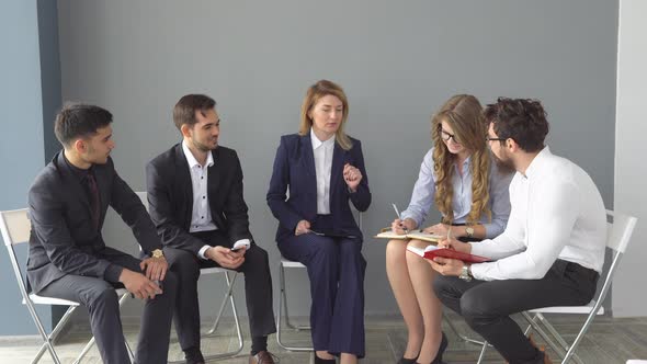 Young Entrepreneur Show Information To Colleagues on the Screen of the Tablet PC. Business Meeting