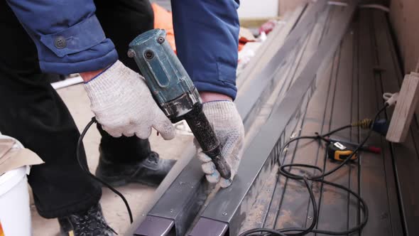 Rivet pistol in action, worker installing rivets