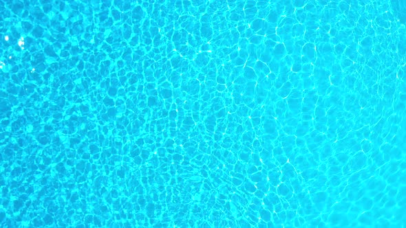 Blue Water in the Swimming Pool with Light Reflections