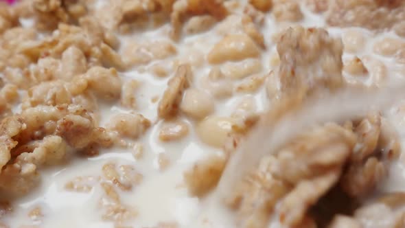 Close-up slow motion mixing  crunch muesli breakfast with milk 1080p HD video - Cereal food meal mix