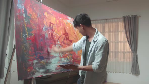 Asian Male Uses Paint Brush To Create Daringly Emotional Modern Picture