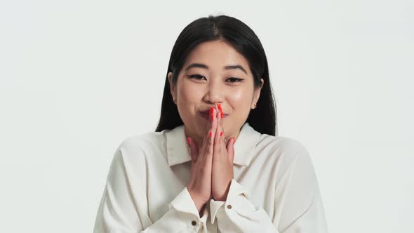 Close-up view of a surprised asian korean woman posing to the camera