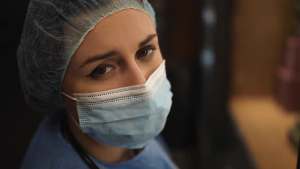 Macro View: Exhausted Female Doctor or Nurse Looks at Patient