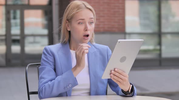 Businesswoman Upset by Loss on Tablet