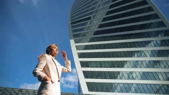 Modern Skyscrapers and Portrait of Young Attractive Businesswoman