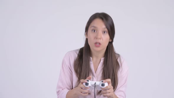 Face of Young Multi-ethnic Businesswoman Playing Games