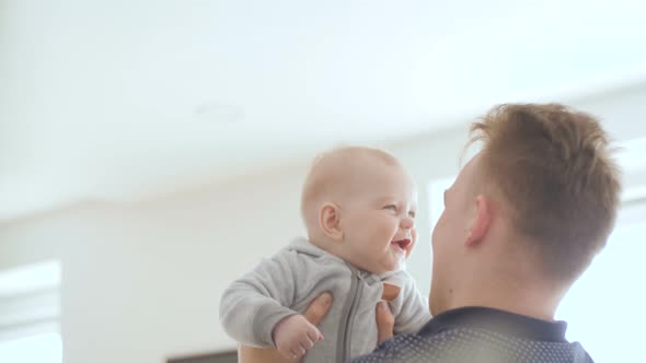 Father Raises Baby In To The Air