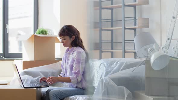 Woman with Laptop and Credit Card at New Home