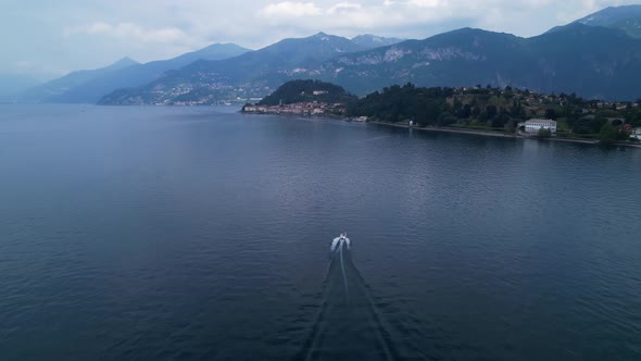 Boat on lake como Italy - speedboat from drone