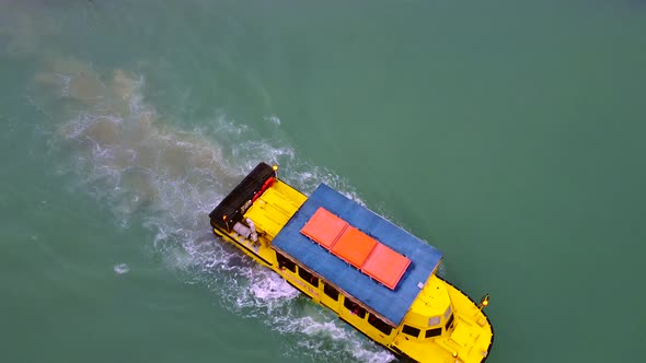 Overhead drone clip of a boat navigating in the strait of Melaka