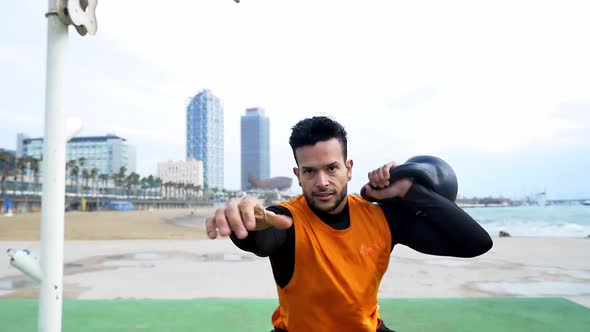 Man training at the beach outdoor gym