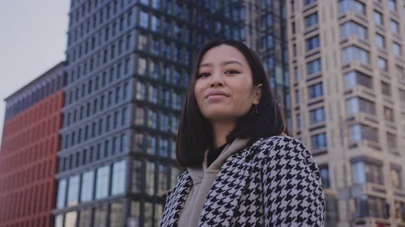 Lowangle Portrait of a Young Adult Asian Woman in Downtown District