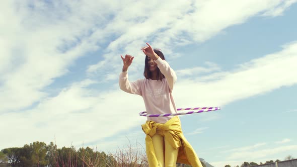 Woman dancing with a hula hoop