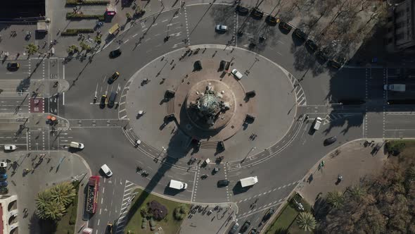AERIAL: Overhead Shot of Columbus Monument Roundabout in Barcelona, Spain with Busy Car Traffic on